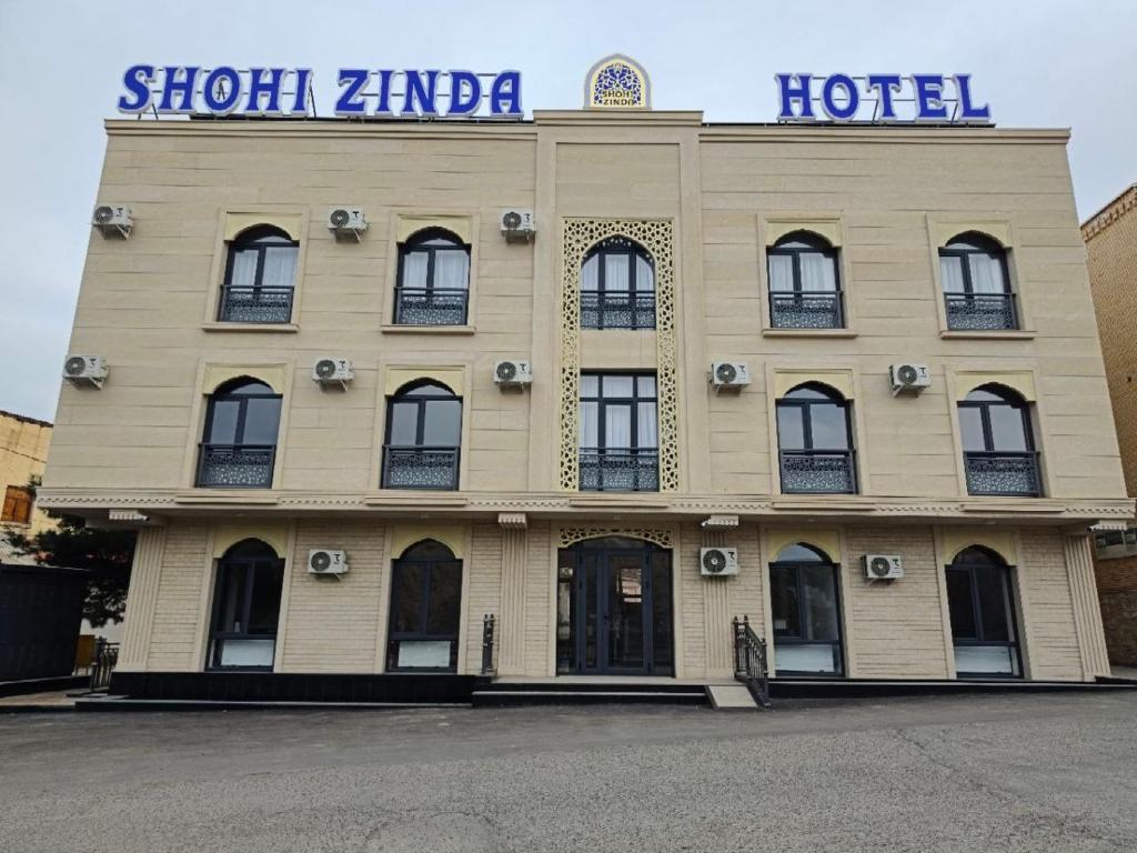 a hotel building with a sign on top of it at SHOHI ZINDA Hotel in Samarkand