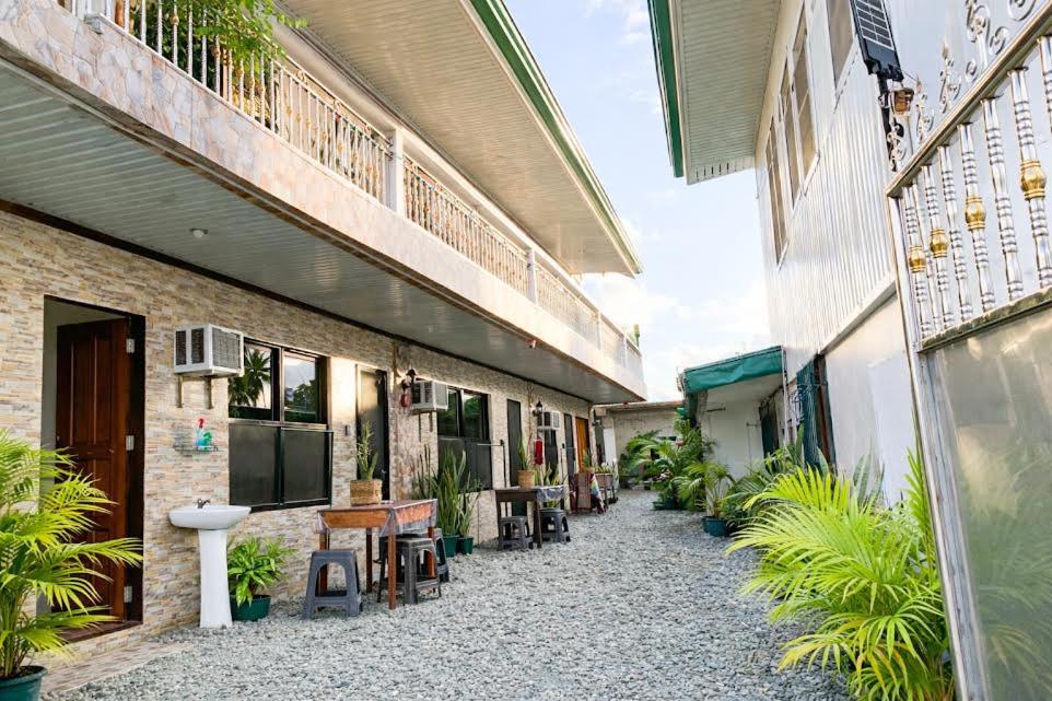 an empty courtyard of a building with plants at PEPAYEN Homestay in General Luna