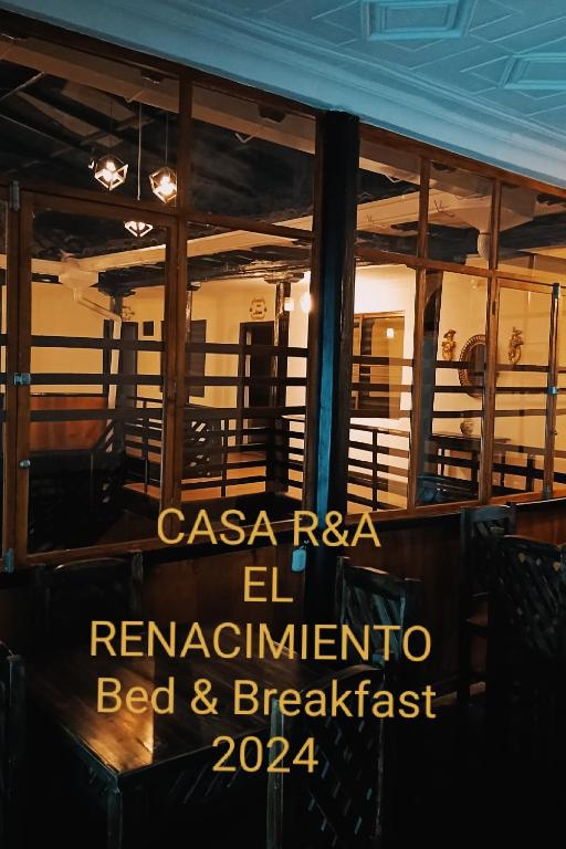 a sign on the window of a restaurant at Suite M a p l e - El Renacimiento Suites in Cuenca