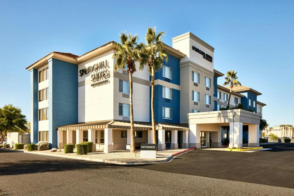 a hotel with palm trees in front of it at SpringHill Suites Phoenix Glendale/Peoria in Peoria