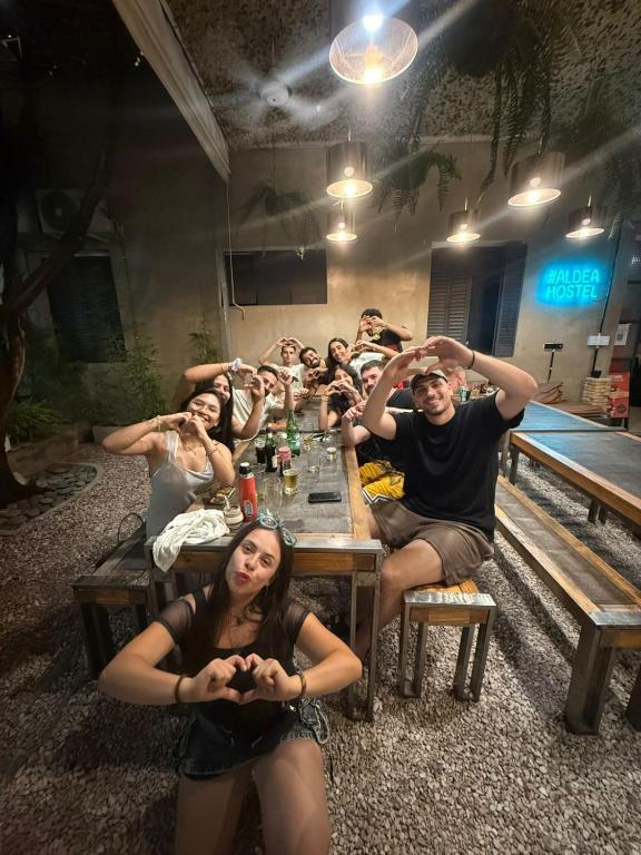 a group of people sitting around a table at Aldea Hostel & Café in Córdoba