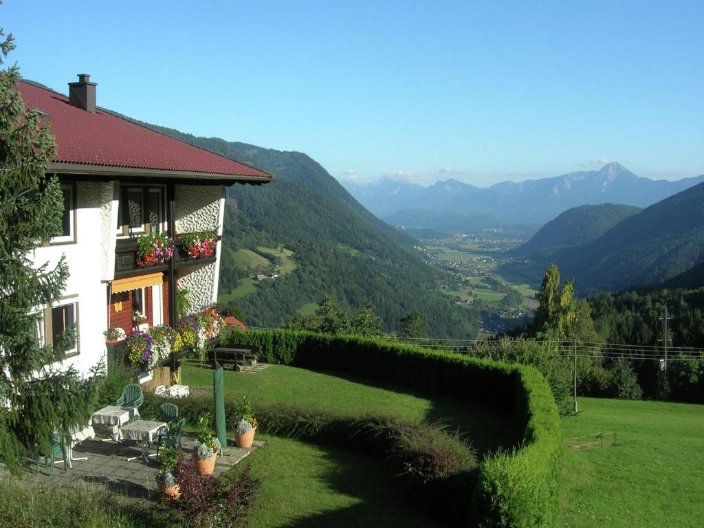 ein Haus auf einem Hügel mit Blick auf die Berge in der Unterkunft Cozy Apartment in Afritz am See near Gerlitzen Ski Area in Afritz