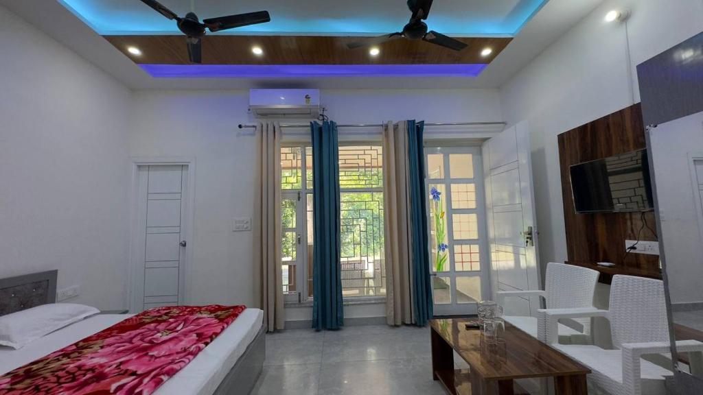 a bedroom with a bed and a table and chairs at Greenvalley Homestay in Rāipur