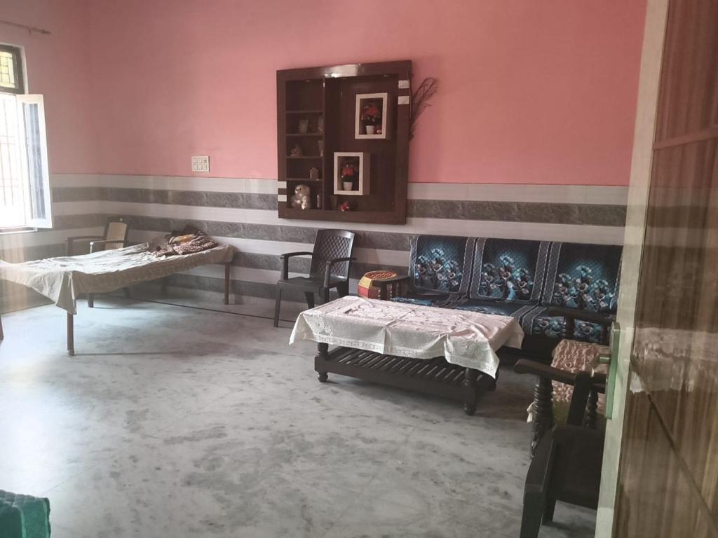 a room with two beds and two tables in it at VIPIN homestay in Bāghpat