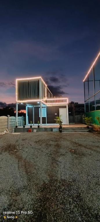 a building with a bus parked in front of it at Amigos rooms in Annavaram