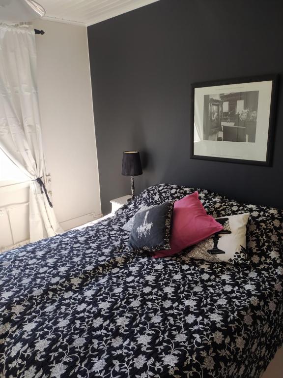 a bed with pillows on it in a bedroom at Villa Alice room 2 in Tampere