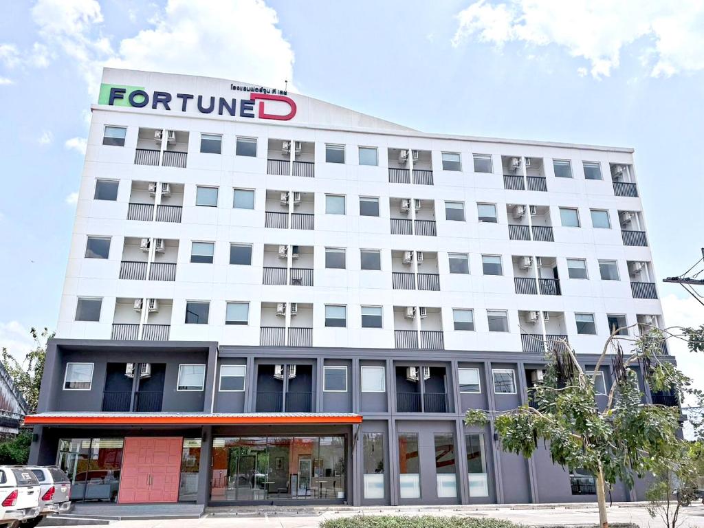 a white building with a ford sign on it at Fortune D Hotel Loei in Loei