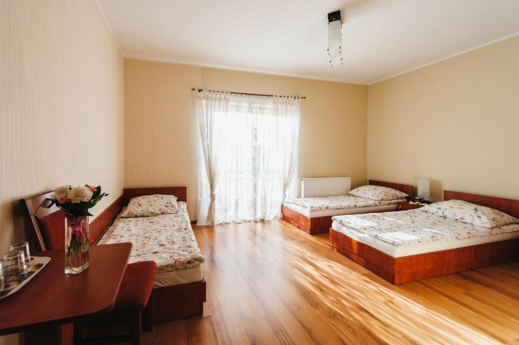 Posteľ alebo postele v izbe v ubytovaní Willa Promyk