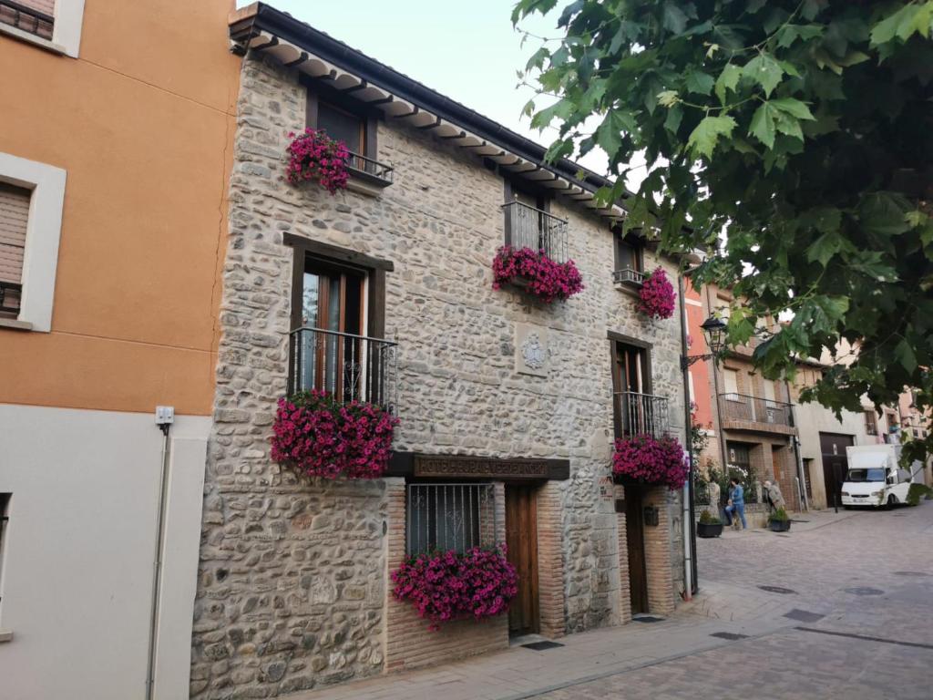 a building with flower boxes on the side of it at Hotel Rural Verdeancho in Belorado