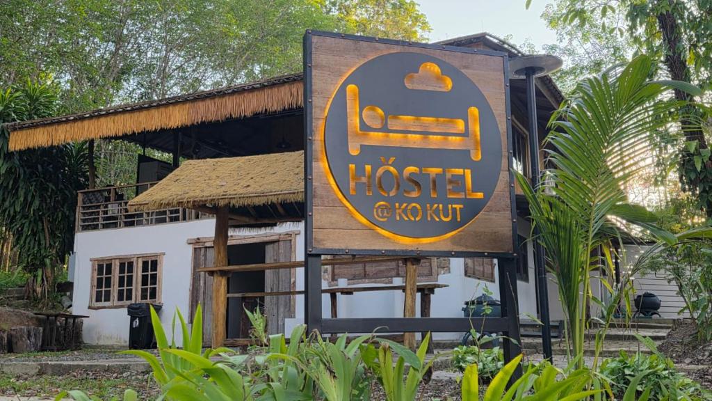 a sign for a hotel in front of a building at Hostel Ko Kut in Ko Kood