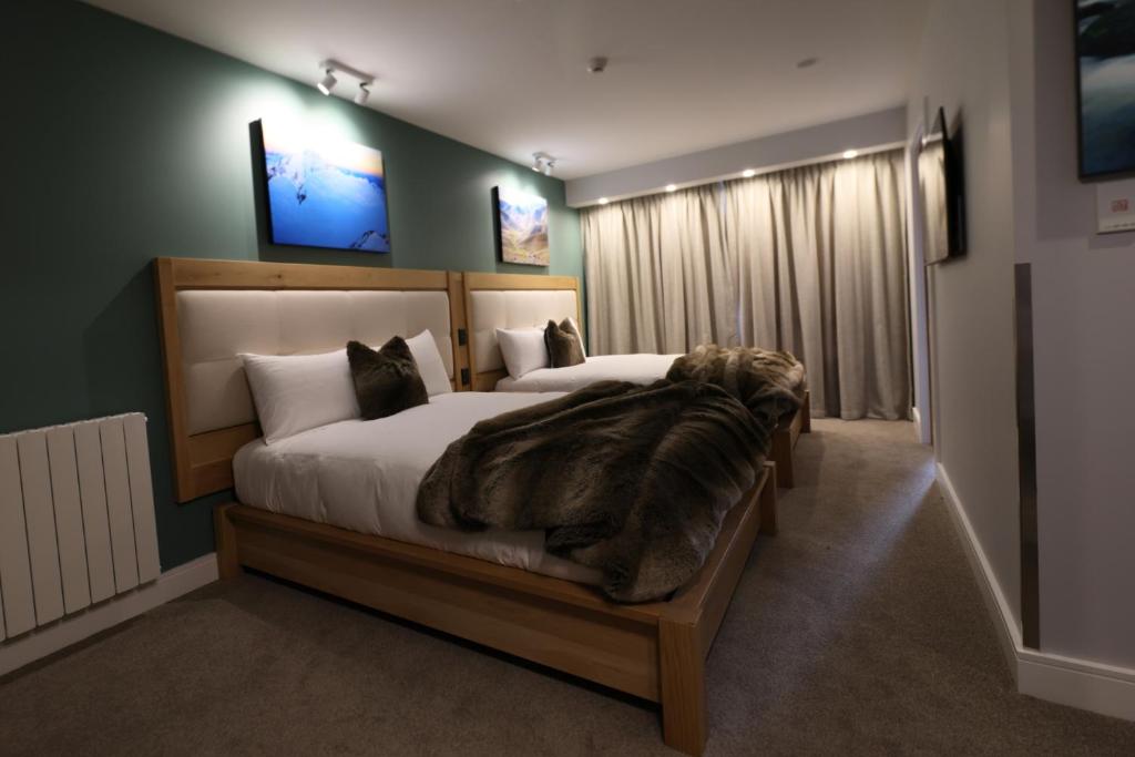 a bedroom with a large dog laying on a bed at Silverstone Lodge in National Park