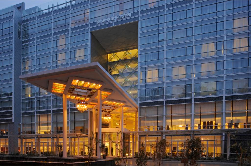 a large glass building with a large building at Dushanbe Serena Hotel in Dushanbe