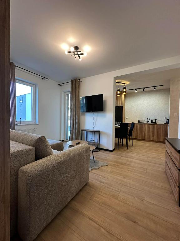 a living room with a couch and a table at Apartament w centrum 5A in Iława