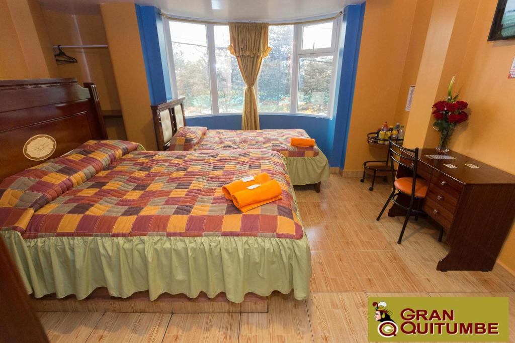Postel nebo postele na pokoji v ubytování Hotel Gran Quitumbe