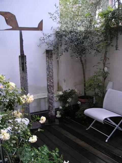 a room with a chair and a cross and flowers at Zum oberen Schulhof in Konstanz
