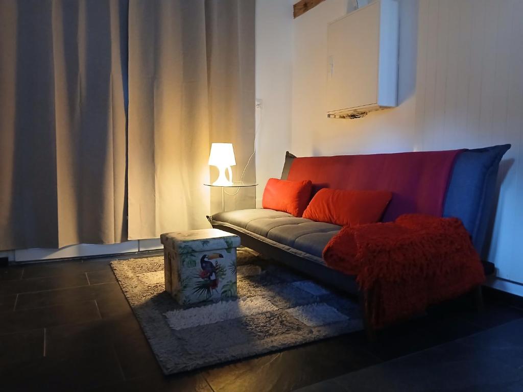 a living room with a couch and a lamp at FeWo Eriswil by R&B in Eriswil