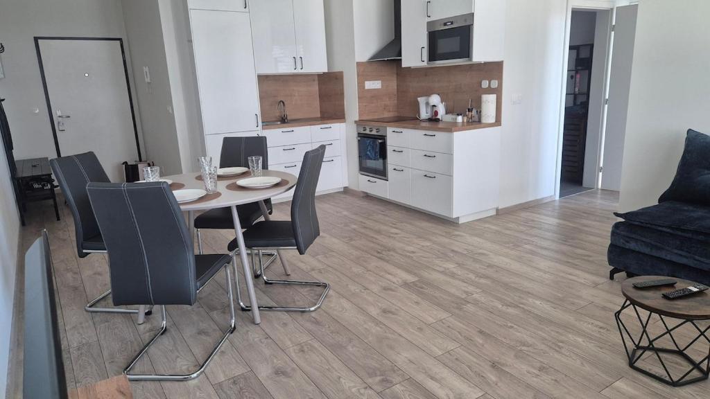 a kitchen and dining room with a table and chairs at 3-room apartment in Trnava