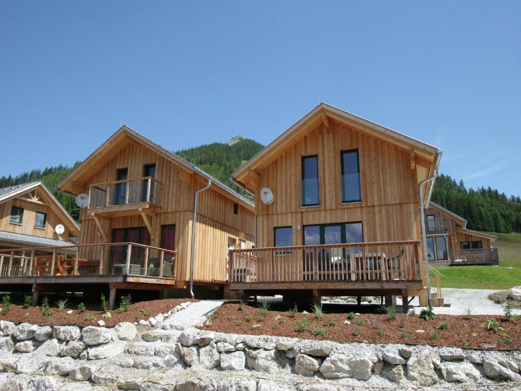 a large log home with balconies and trees at Chalet in Hohentauern am Skilift in Hohentauern