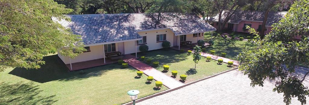 an aerial view of a house with a yard at Victoria Apartments in Livingstone