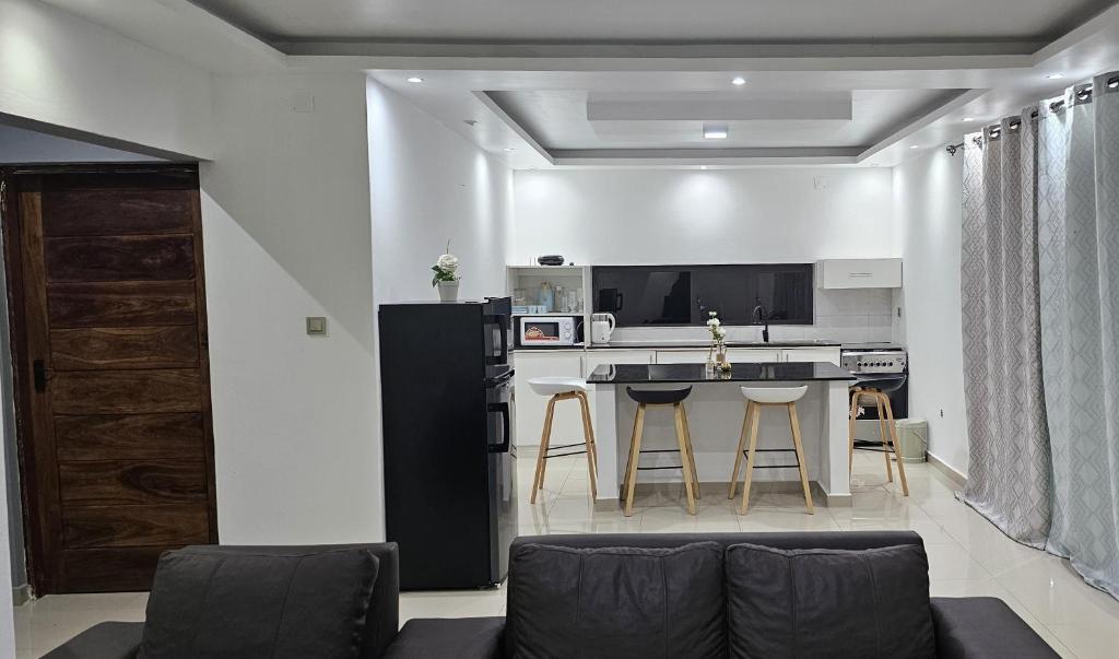 a living room with a couch and a kitchen at Bilene Harmony Home in Vila Praia Do Bilene