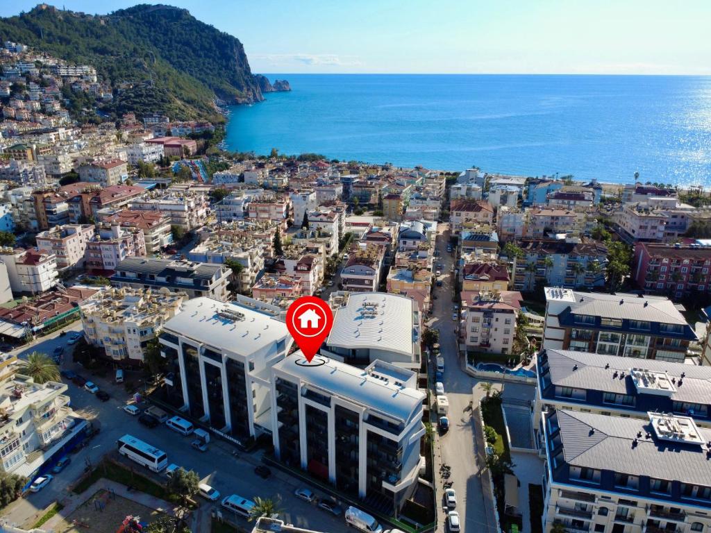 a city with a red sign on top of a building at SA Apartments! Cleopatra Beach Duplex with Terrace in Alanya