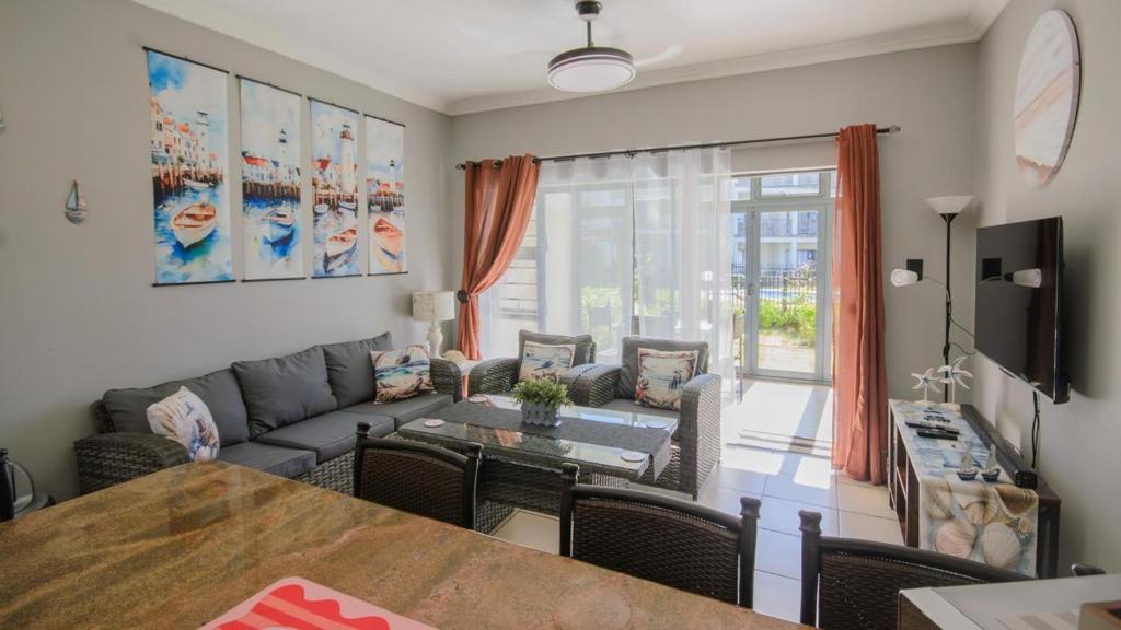 a living room with a couch and a table at 7 Topanga in Uvongo Beach