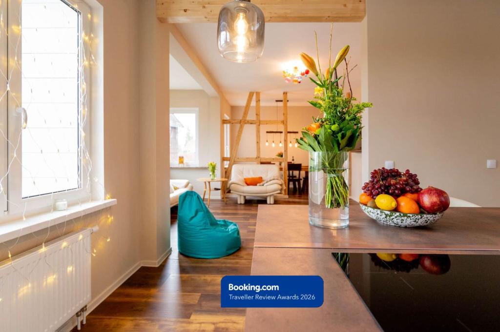 a kitchen with a vase of fruit and flowers on a counter at CHALET627 in Braunlage