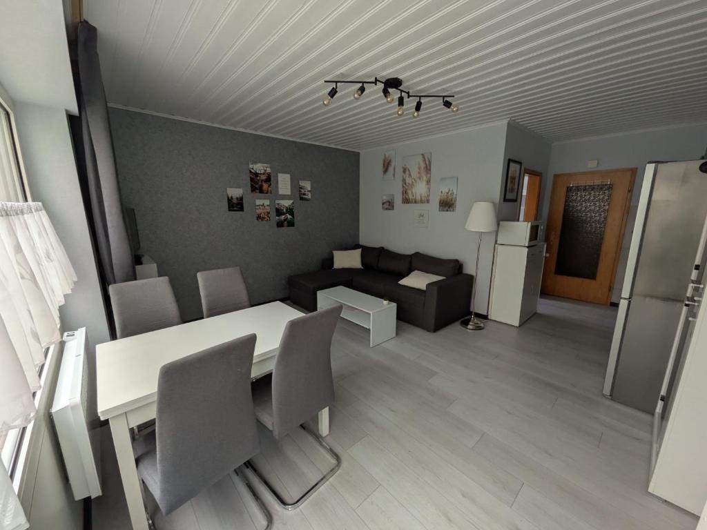 a kitchen and living room with a table and a couch at Ferienwohnung Tanja in Winterberg