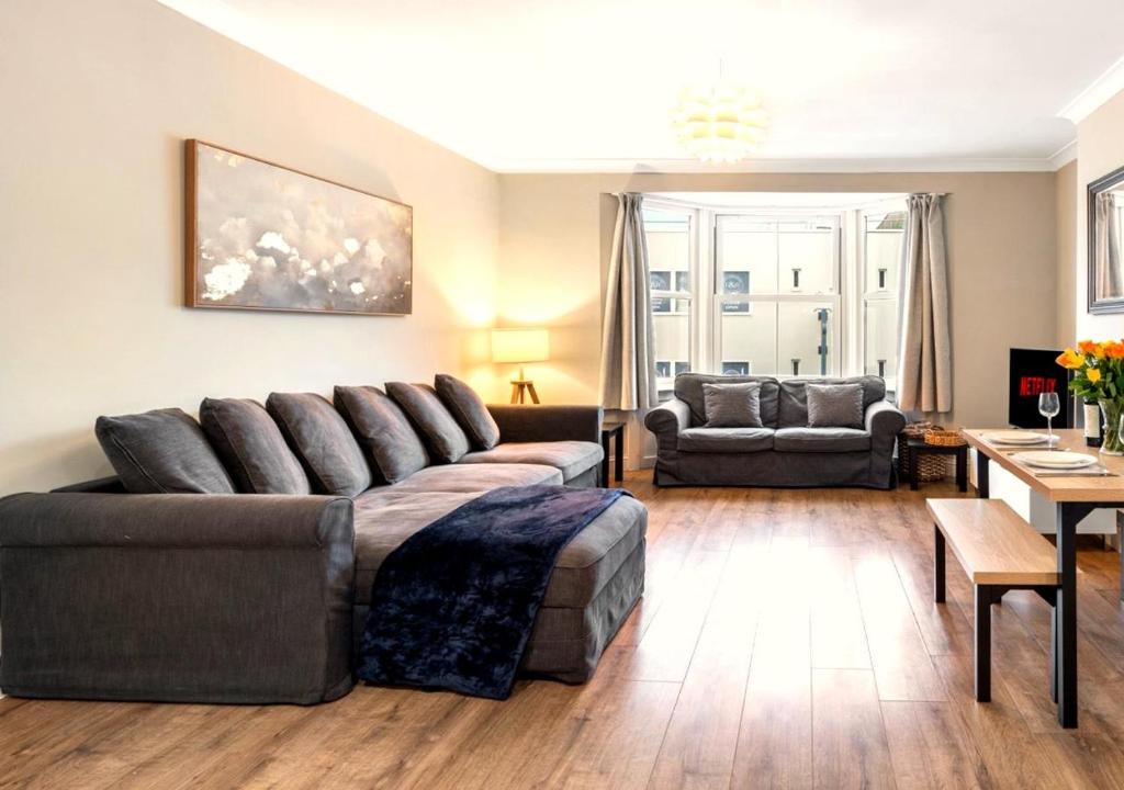 a living room with a couch and a table at Spacious - Central - King Beds - Fast Wi-Fi in Brighton & Hove