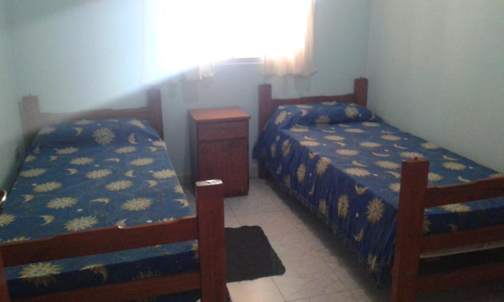 1 dormitorio con 2 camas y ventana en Bungalows Anita en Colón