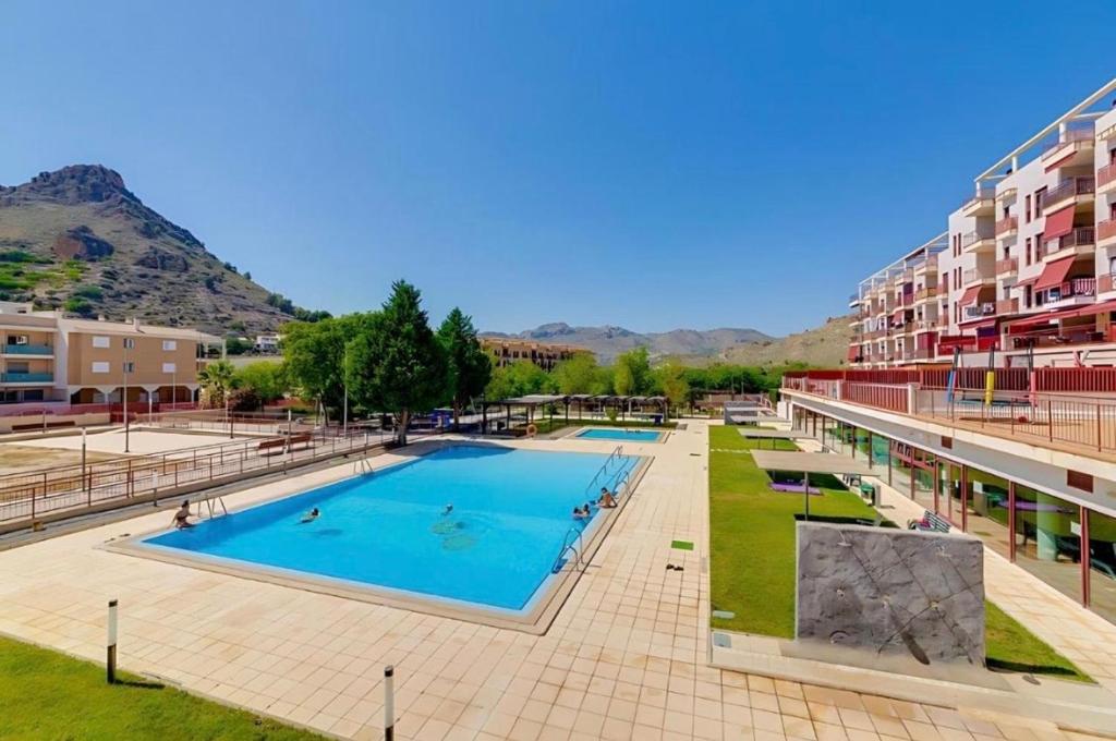 a large swimming pool in a city with buildings at Spa Valley II experiences Penthouse con Piscina climatizada y Yacuzzi in Villanueva de Río Segura