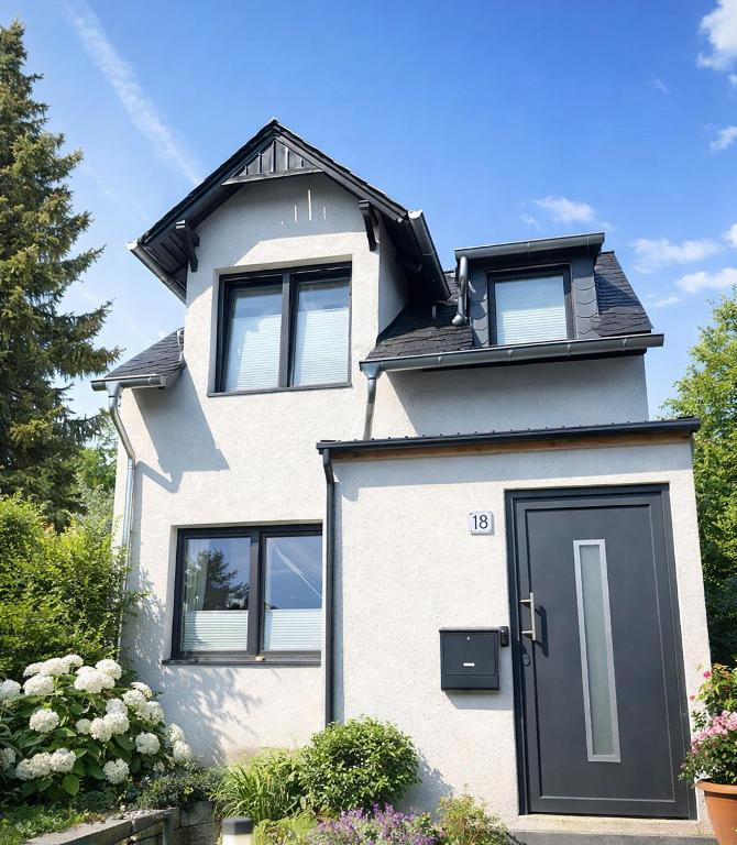 a white house with a black door at MiniLoft Andernach in Andernach