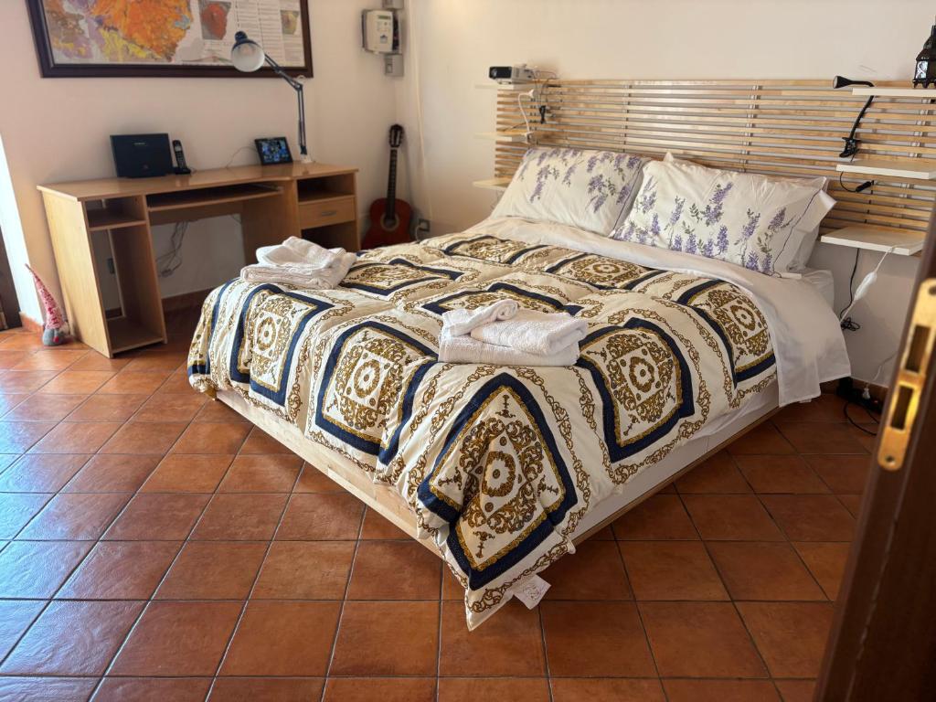a bedroom with a bed with a table and a desk at Soffio dell'Etna in Puntalazzo