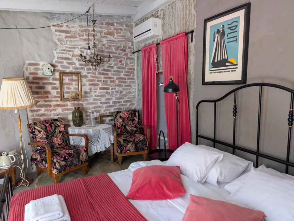 a bedroom with a bed and a table and chairs at Livo Disno 12 in Split