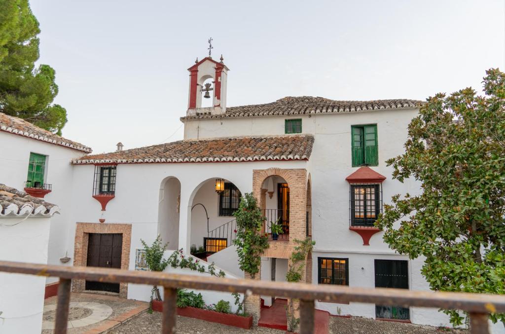 a large white building with a tower on top at Cortijo el Vicario in Ronda