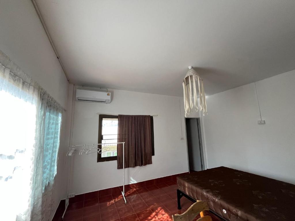 a dining room with a table and a window at Honey Zen Zone in Ko Mak