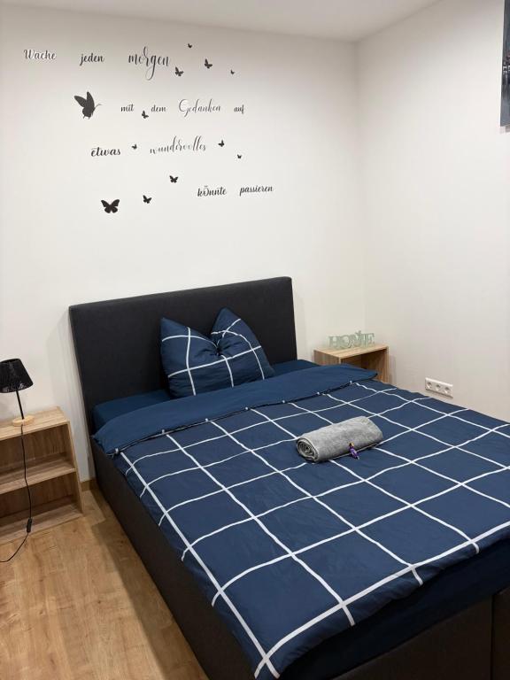 a bedroom with a bed with butterflies on the wall at Urban Stay & Style in Parsberg