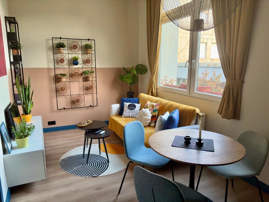 a living room with a table and a couch at Buda's Hidden Heaven 1 with Private Sauna in Budapest