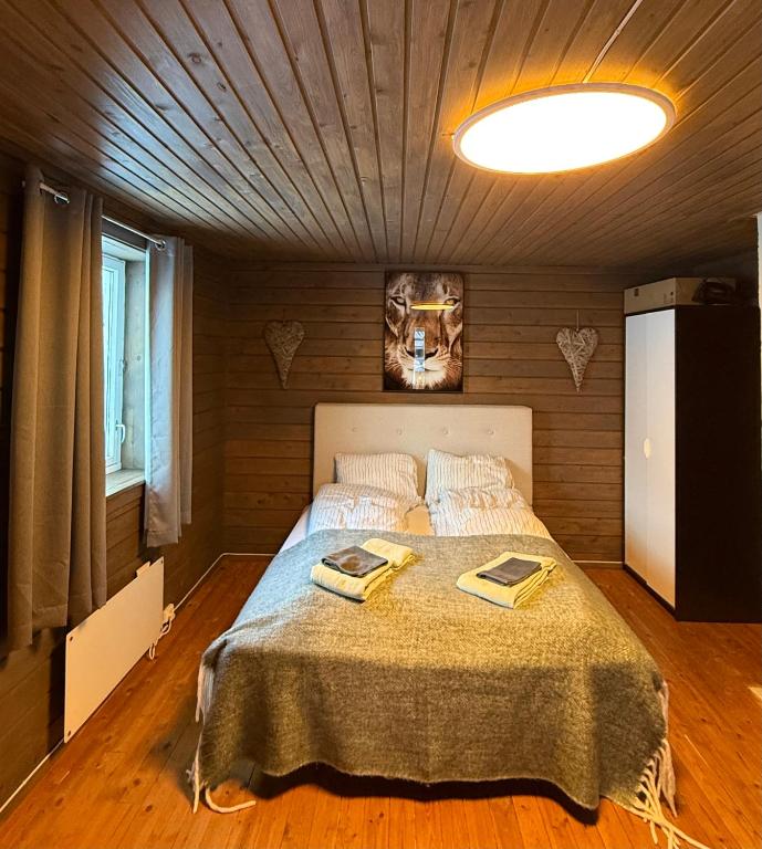 a bedroom with a bed with two books on it at Holiday Suite in Bugøynes
