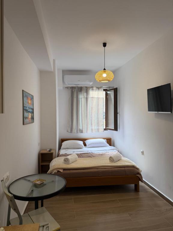 a bedroom with a bed and a glass table at Mare Studio by All Around in Heraklio
