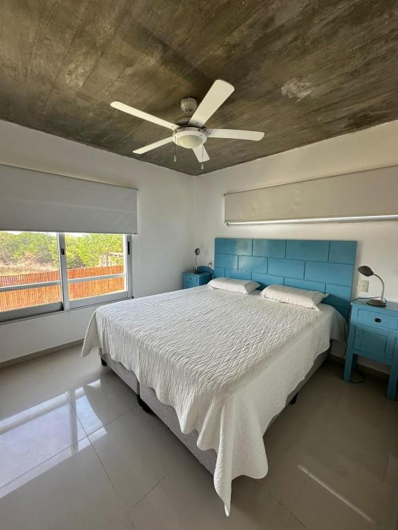 a bedroom with a bed and a ceiling fan at Arenas Garzón in José Ignacio