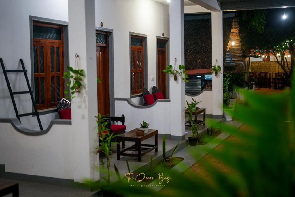 a house with chairs and a table in front of it at The Dream Bay in Arugam Bay