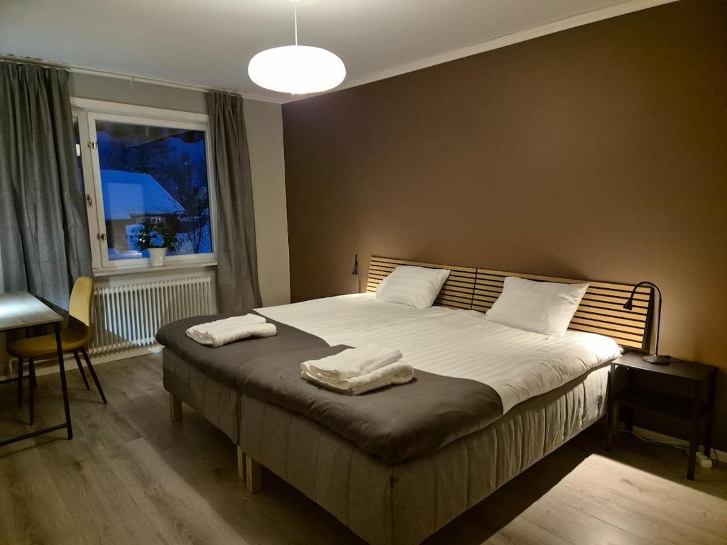 a bedroom with a bed with two towels on it at RåneVillan in Råneå
