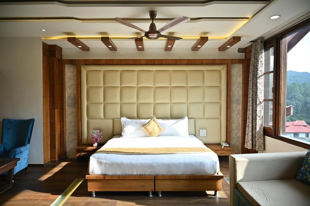 a bedroom with a large bed and a couch at The Hoften Blue Magnets, Dalhousie in Dalhousie
