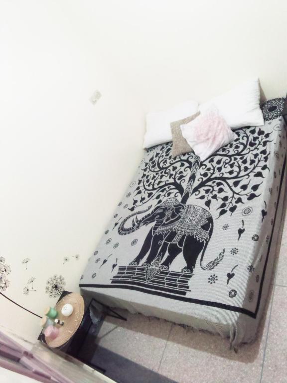 a bed with a black and white bedspread with an elephant on it at Budget Friendly -Private Room in a Moroccan Home - Host On Site in Agadir