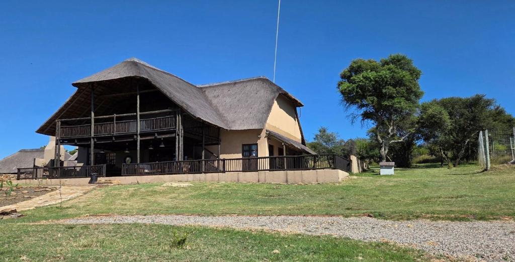 a large house with a gambrel roof at Vaalkrans Game Lodge in Heilbron