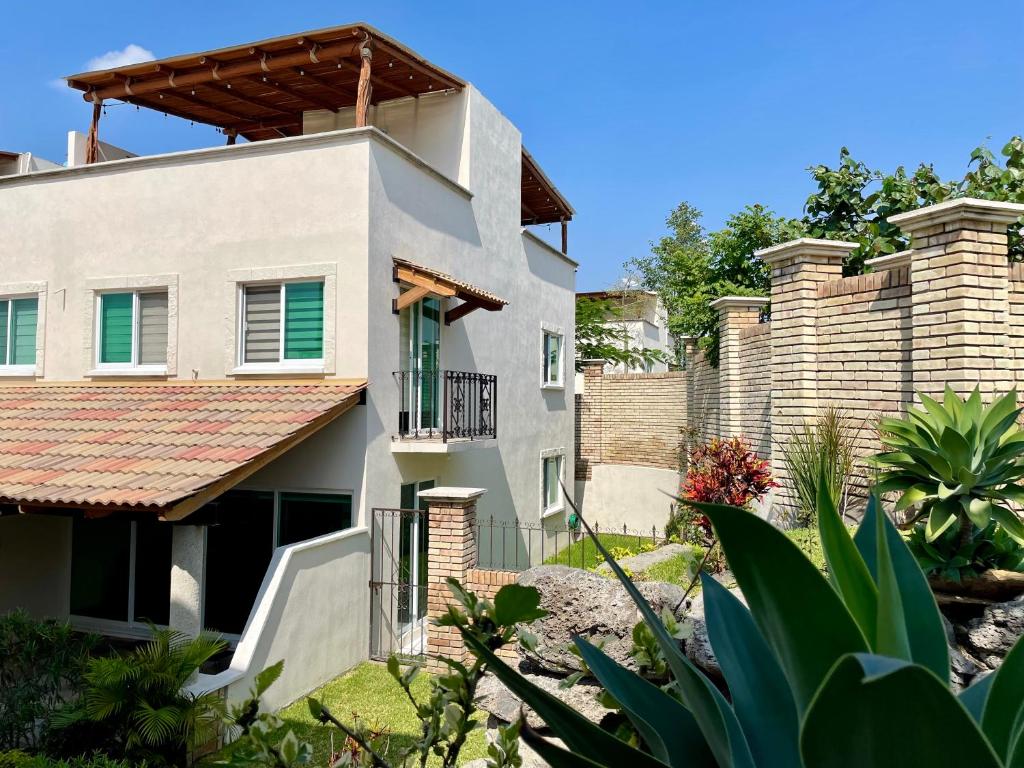 an image of a house with a fence at Casa Boho - Heated Pool, Private Grill & Garden - Xochitepec in Tezoyuca