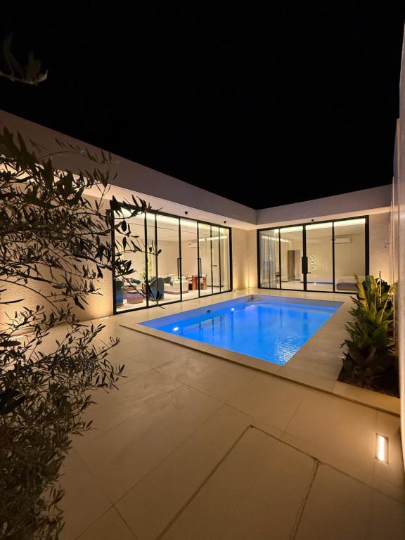 a swimming pool in a house at night at شاليه جازلي in Riyadh