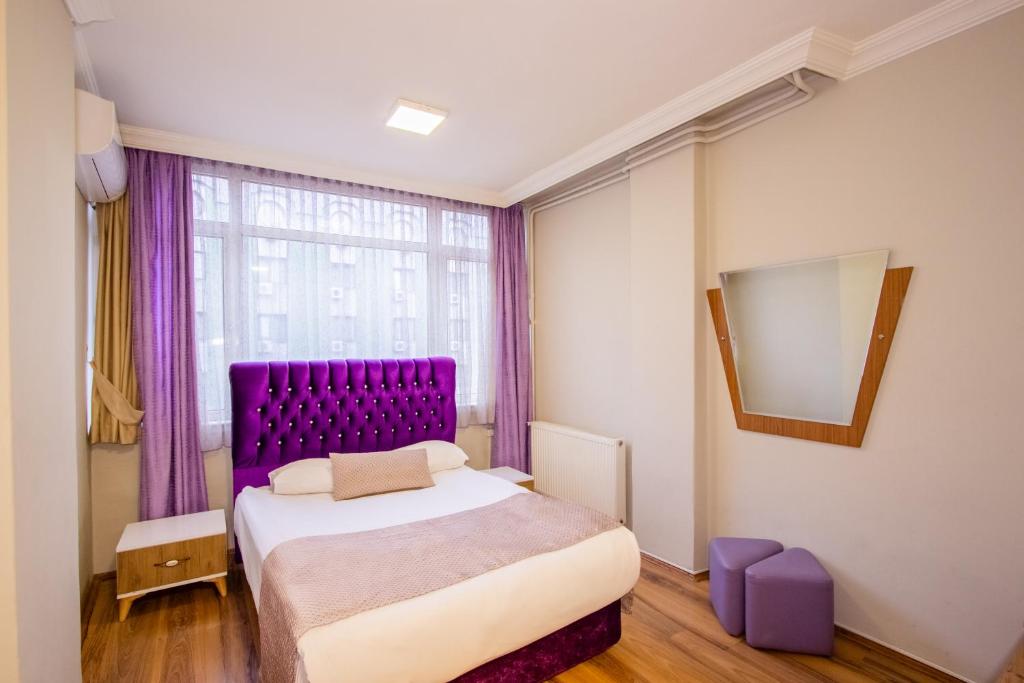 Postel nebo postele na pokoji v ubytování Tac Hotel