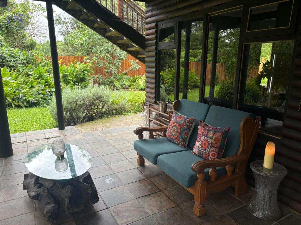 a patio with a couch and a table with a candle at Dragon Fly in Stormsrivier